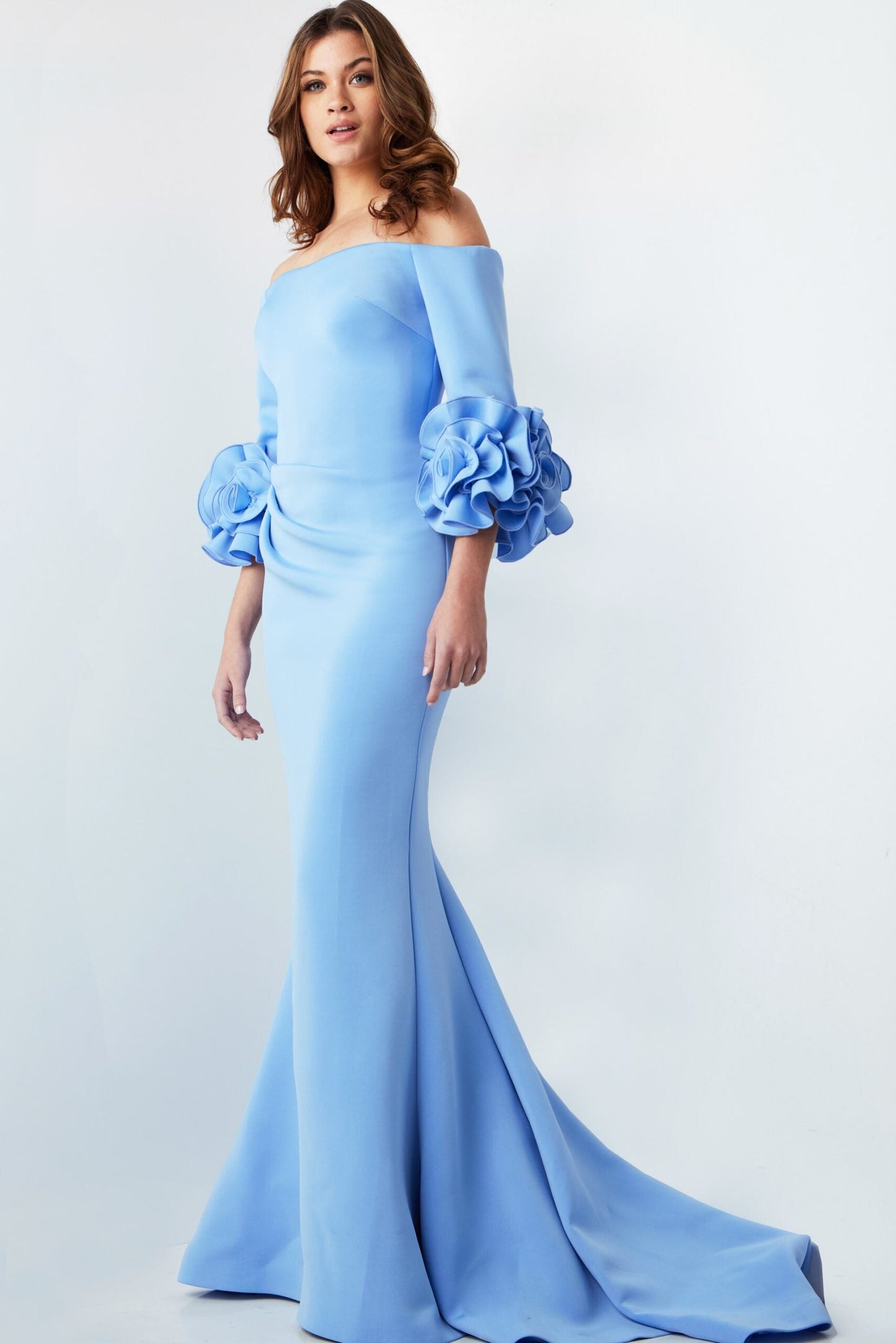 Jovani 23716 Off-the-Shoulder Scuba Gown – Elegant light blue gown featuring an off-the-shoulder neckline, sheath silhouette, and floral sleeve details.