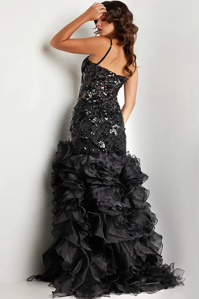 Jovani 38358 Sequin Embellished Mermaid Evening Gown - A glamorous gown featuring an organza ruffle skirt with a slit, sequin embellished bodice with boning and illusion waist, and a mermaid silhouette with a sweetheart neckline. The model is showcasing the dress in black.