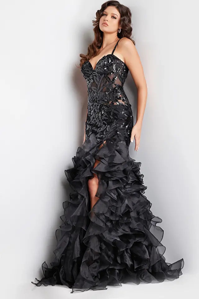 Jovani 38358 Sequin Embellished Mermaid Evening Gown - A glamorous gown featuring an organza ruffle skirt with a slit, sequin embellished bodice with boning and illusion waist, and a mermaid silhouette with a sweetheart neckline. The model is showcasing the dress in black.