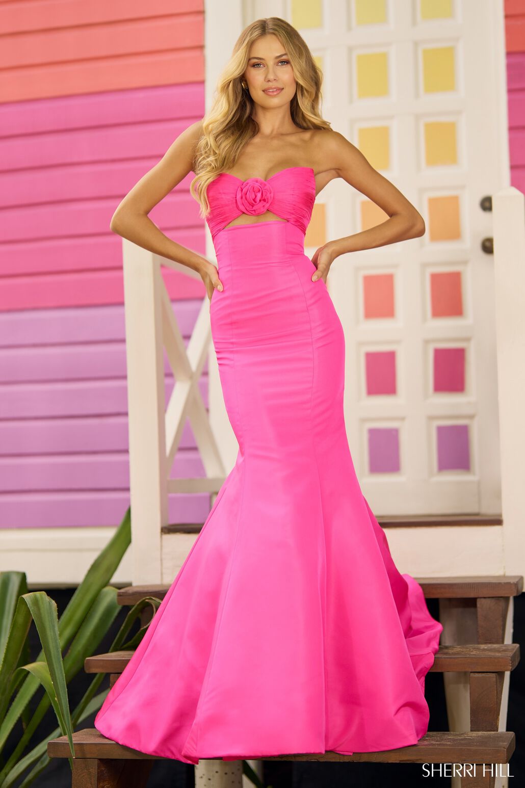 A mesmerizing strapless taffeta mermaid prom gown with a ruched neckline, keyhole, and intricate flower detail on the bodice. Perfect for prom or evening events.