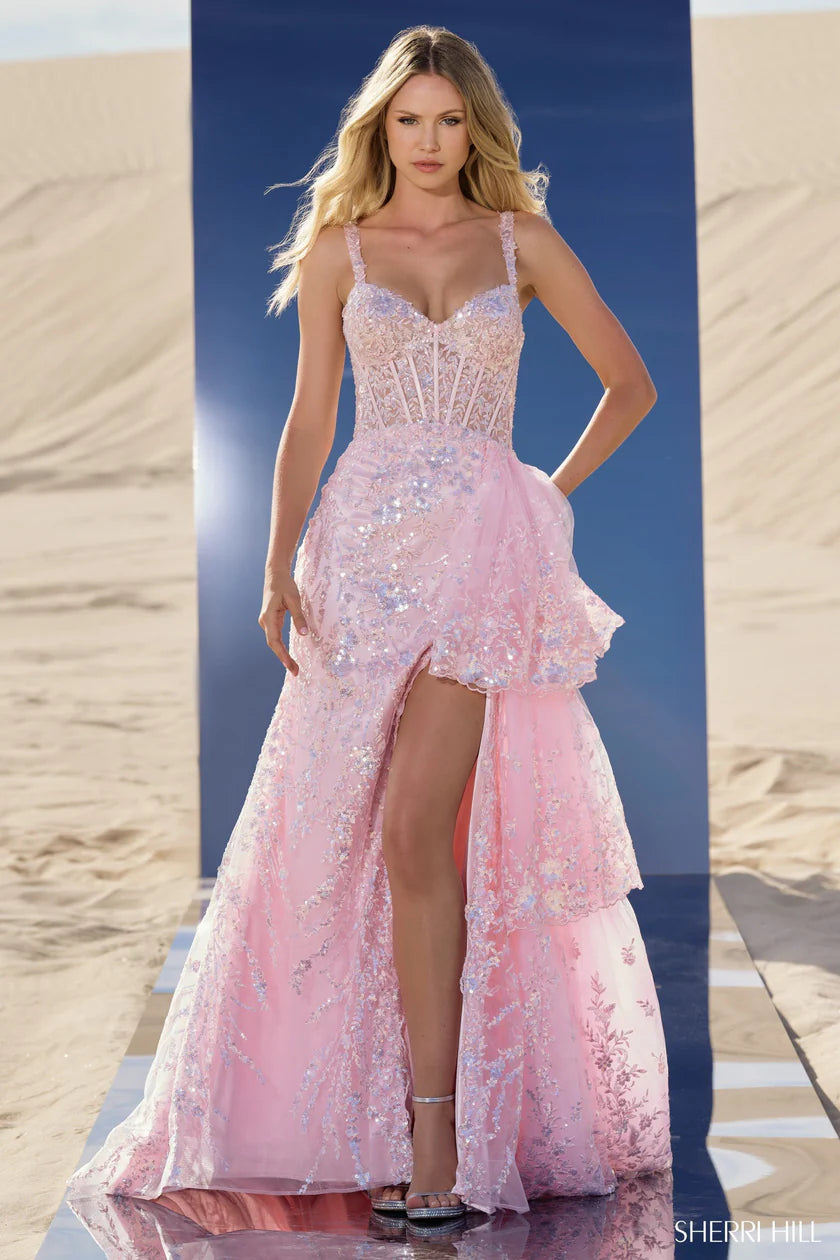 Sherri Hill 56589 sequin corset gown in pink with ruffle overskirt and high slit, perfect for prom and formal evenings.