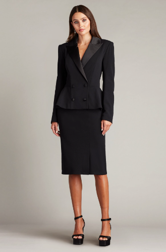 A woman wearing a long-sleeved textured crepe evening dress with a tuxedo collar, perfect for elegant evening occasions.