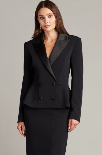 A woman wearing a long-sleeved textured crepe evening dress with a tuxedo collar, perfect for elegant evening occasions.