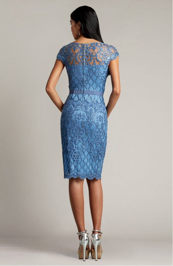 Tadashi Shoji BJK18795 Embroidered Tulle Sheath Dress - Sophisticated knee-length dress with sparkly paillette embellishments, plunging illusion neckline, attached grosgrain elastic belt, and fitted sheath silhouette.