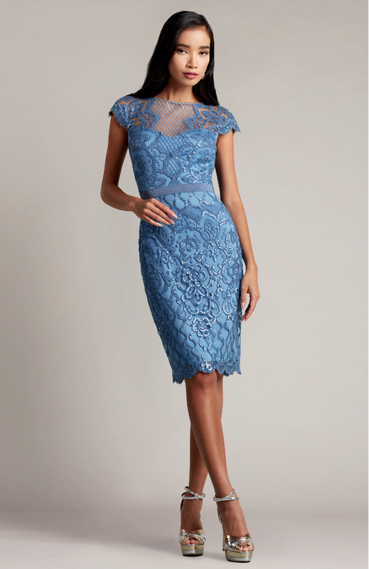 Tadashi Shoji BJK18795 Embroidered Tulle Sheath Dress - Sophisticated knee-length dress with sparkly paillette embellishments, plunging illusion neckline, attached grosgrain elastic belt, and fitted sheath silhouette.