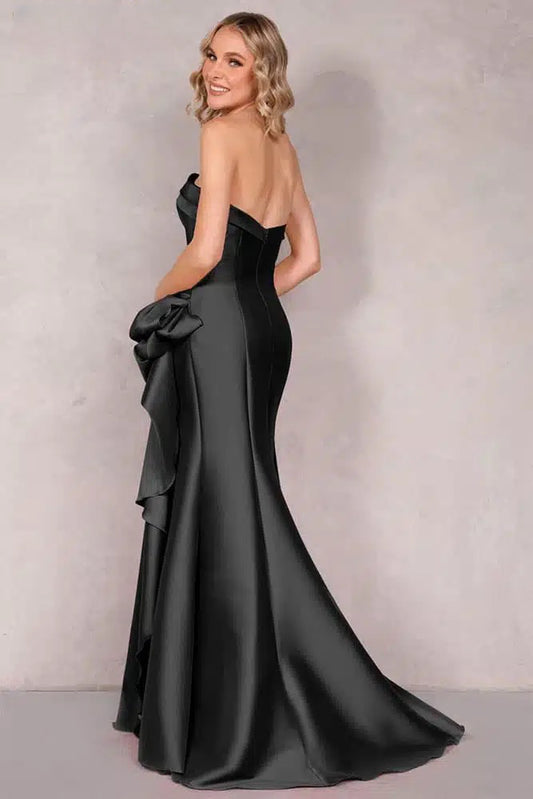 A stunning Mikado evening dress by Terani with an off-shoulder neckline, open back, and a draped bow feature on the waist. Perfect for evening events and as a mother-of-the-bride or mother-of-the-groom dress.